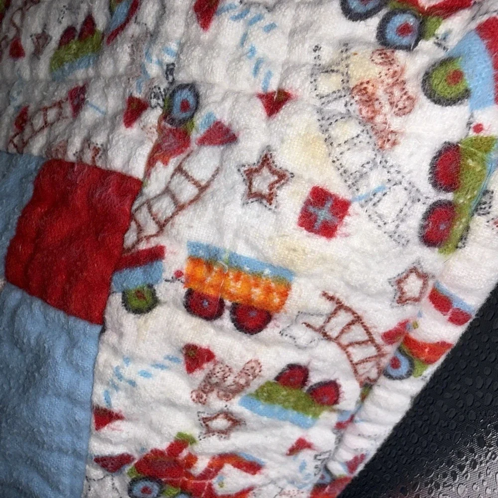 Vtg Baby Quilt Of Trains Print bordered by blue sashing and red cornerstones